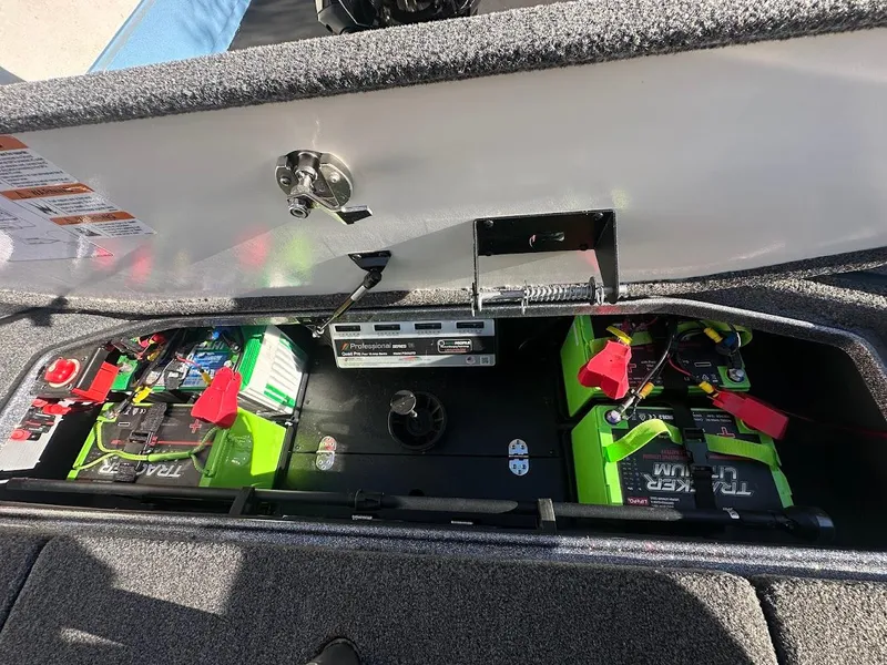 Slide: The Image of 2024 Ranger Z520R boat battery compartment with green batteries and wiring. - 29