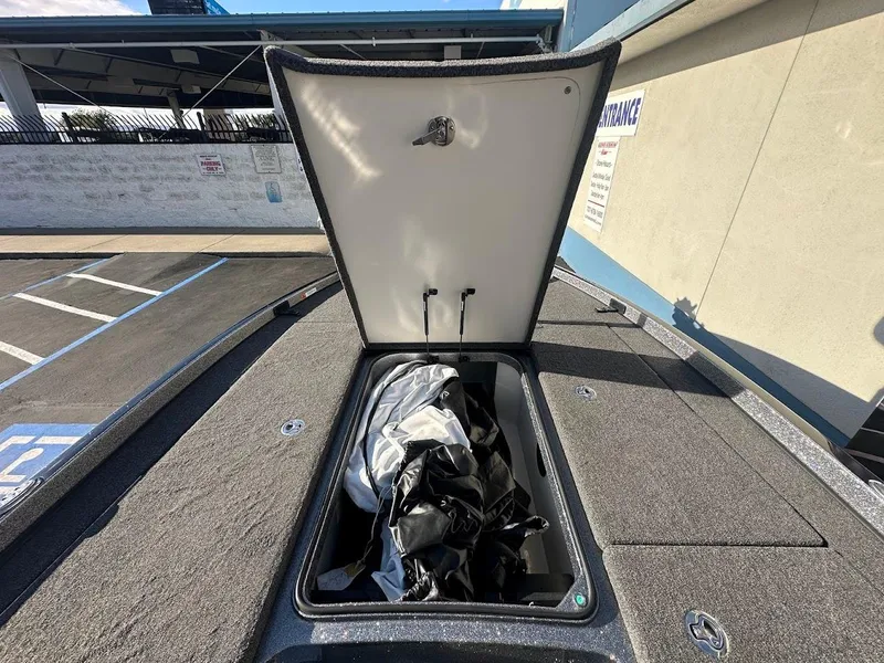 Slide: The Image of 2024 Ranger Z520R storage compartment open, showing interior space and contents. - 30