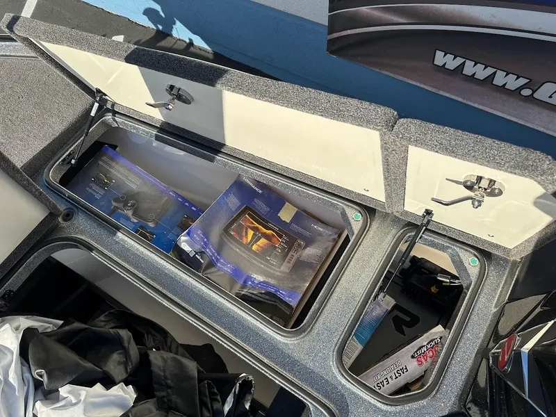 Slide: The Image of 2024 Ranger Z520R storage compartment with fishing gear and accessories. - 31