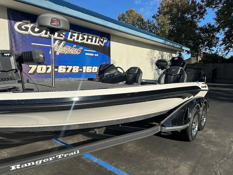 Slide: The Image of 2024 Ranger Z520R Ranger Cup Equipped boat on trailer, parked outside a fishing store. - 5