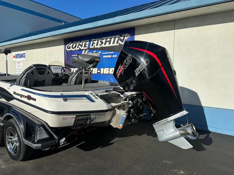 Slide: The Image of 2024 Ranger Z520R boat with powerful outboard motor, parked outside dealership. - 8
