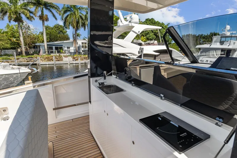 Slide: The Image of 2023 Astondoa 377 Coupe Outboard yacht interior with modern kitchen and waterfront view. - 16