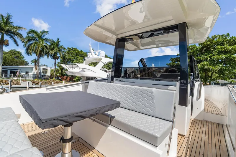Slide: The Image of 2023 Astondoa 377 Coupe Outboard yacht deck with seating and table. - 18