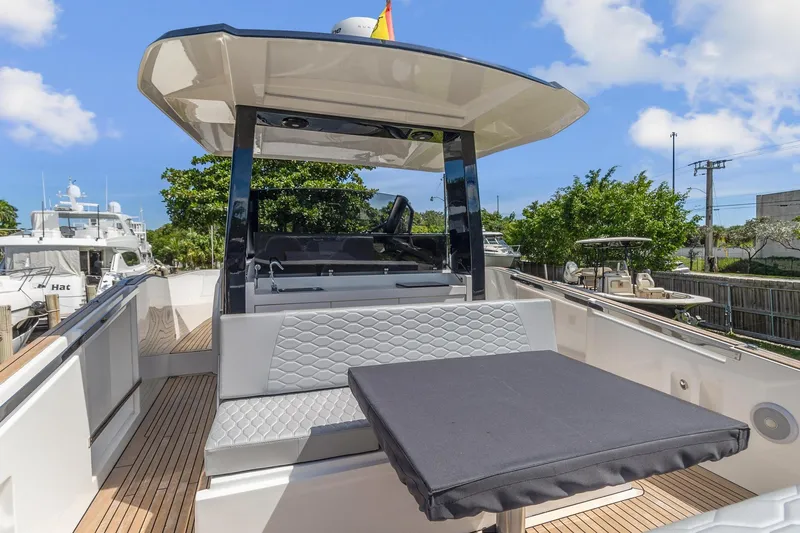 Slide: The Image of 2023 Astondoa 377 Coupe Outboard yacht with modern seating and table on deck. - 19