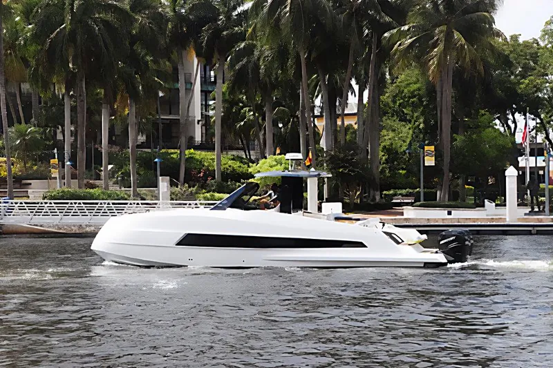 Slide: The Image of 2023 Astondoa 377 Coupe Outboard cruising on a river with palm trees in the background. - 3