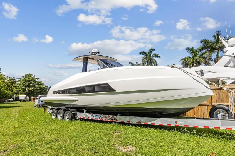 Slide: The Image of 2023 Astondoa 377 Coupe Outboard on trailer, side view, outdoors. - 6