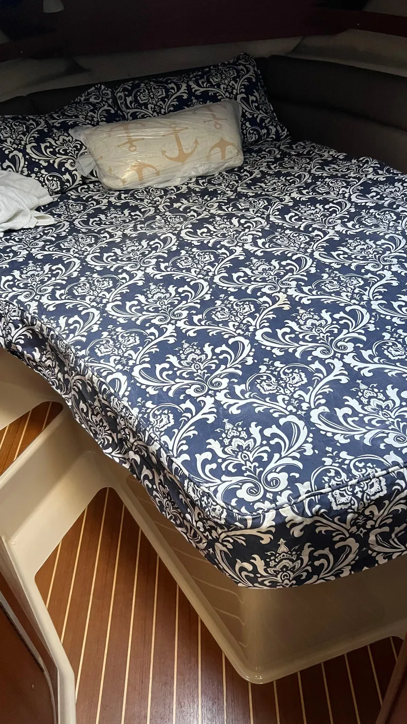 Slide: The Image of Cozy cabin bed in 2014 Ranger Tugs R29S with patterned bedding. - 17