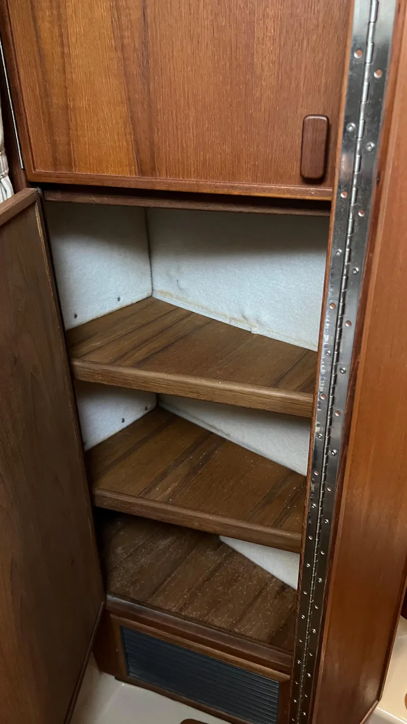 Slide: The Image of Wooden shelving inside 2014 Ranger Tugs R29S boat cabin. - 19