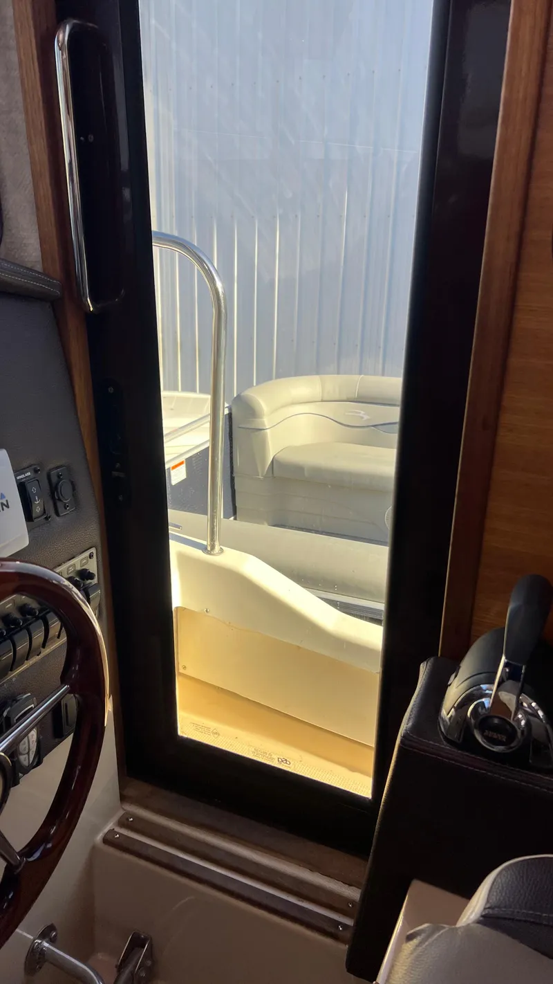 Slide: The Image of Interior view of 2014 Ranger Tugs R29S boat, showing helm and seating area. - 22