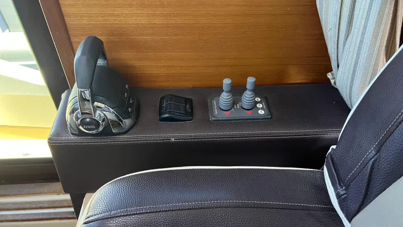 Slide: The Image of 2014 Ranger Tugs R29S boat controls with joystick and throttle levers. - 23