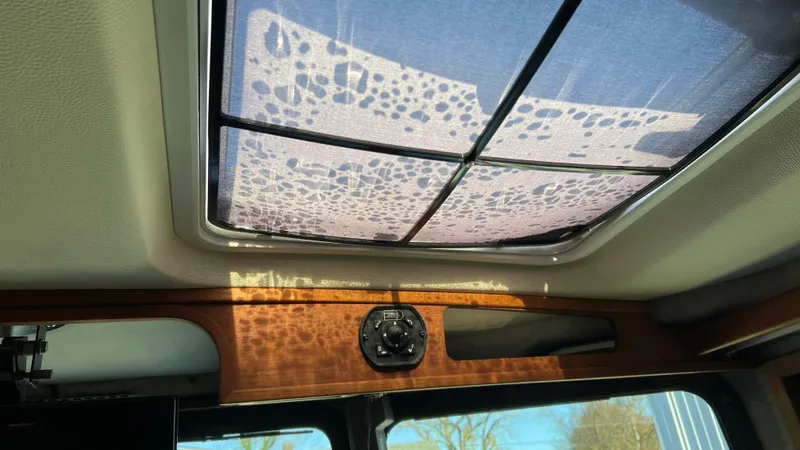 Slide: The Image of 2014 Ranger Tugs R29S interior with sunroof and wooden trim detail. - 29