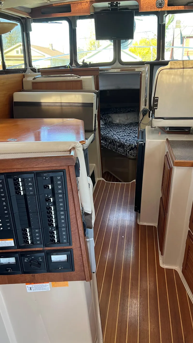 Slide: The Image of Interior of 2014 Ranger Tugs R29S boat with wood flooring and control panel. - 31