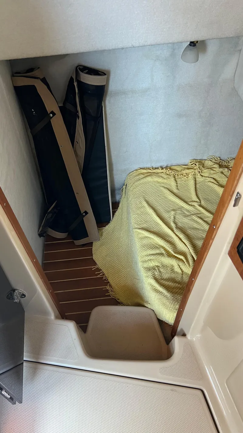 Slide: The Image of Cozy cabin interior of 2014 Ranger Tugs R29S with bed and storage space. - 32