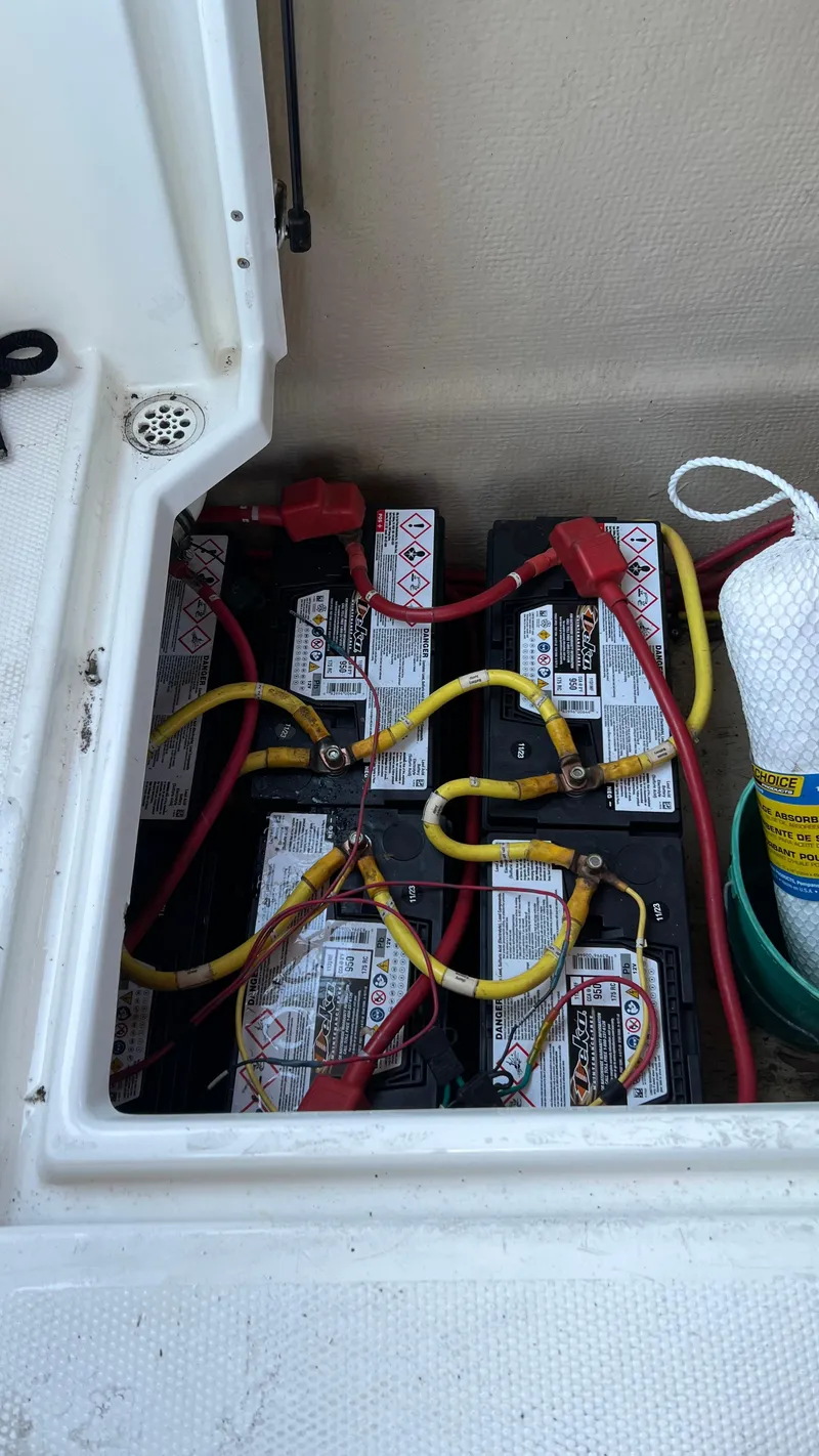 Slide: The Image of 2014 Ranger Tugs R29S boat battery compartment with multiple connected batteries. - 42