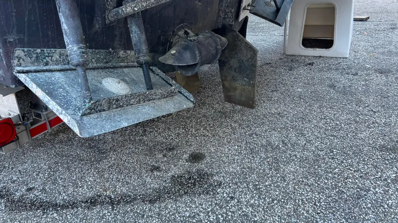 Slide: The Image of Close-up of 2014 Ranger Tugs R29S boat propeller and rudder on gravel surface. - 46