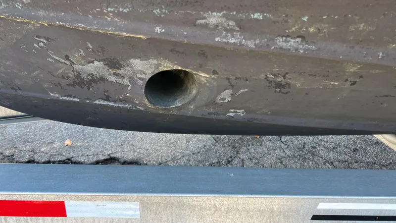 Slide: The Image of Close-up of 2014 Ranger Tugs R29S hull with visible wear and hole. - 47