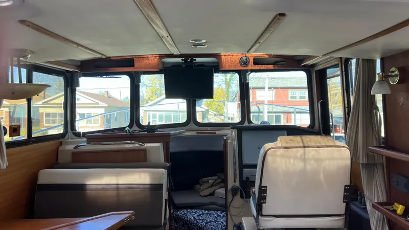 Slide: The Image of Interior of 2014 Ranger Tugs R29S boat, featuring helm and seating area. - 6