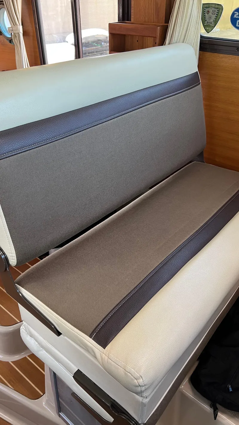 Slide: The Image of Interior seating of 2014 Ranger Tugs R29S boat, featuring cushioned bench. - 8