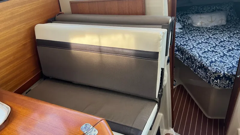 Slide: The Image of Interior of 2014 Ranger Tugs R29S with seating and patterned bedding. - 9