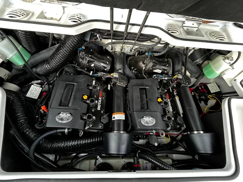 Slide: The Image of 2024 Scarab 215 Wake LE boat engine compartment with dual Rotax engines. - 11