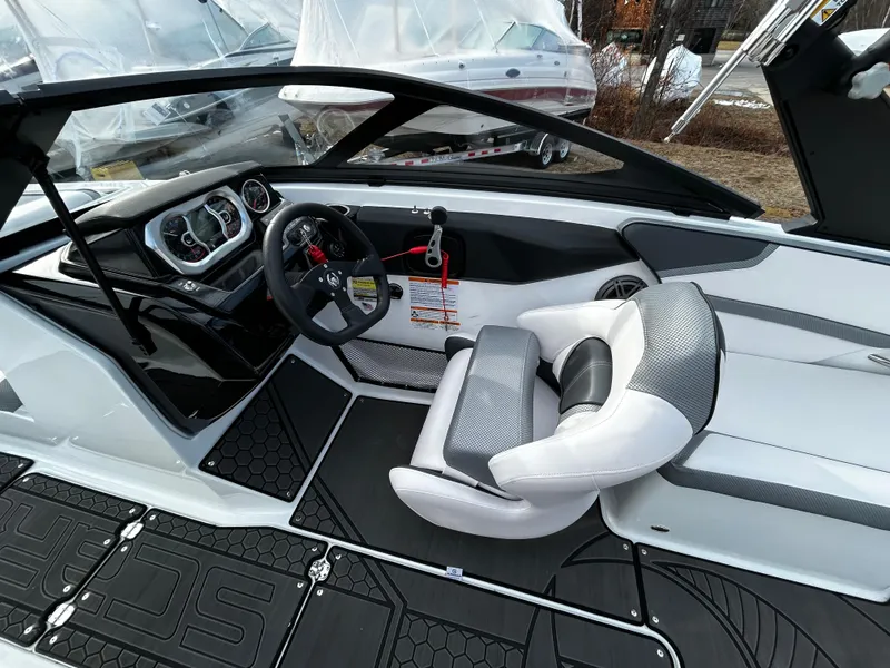 Slide: The Image of 2024 Scarab 215 Wake LE boat interior with modern dashboard and comfortable seating. - 17