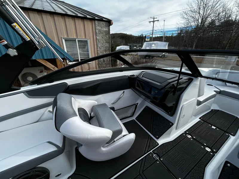 Slide: The Image of 2024 Scarab 215 Wake LE boat interior with modern dashboard and seating. - 20