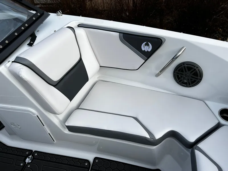 Slide: The Image of 2024 Scarab 215 Wake LE boat interior seating with white and black upholstery. - 24