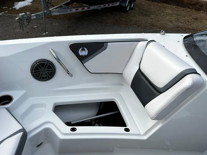Slide: The Image of 2024 Scarab 215 Wake LE boat interior with white and black seating and storage compartment. - 29