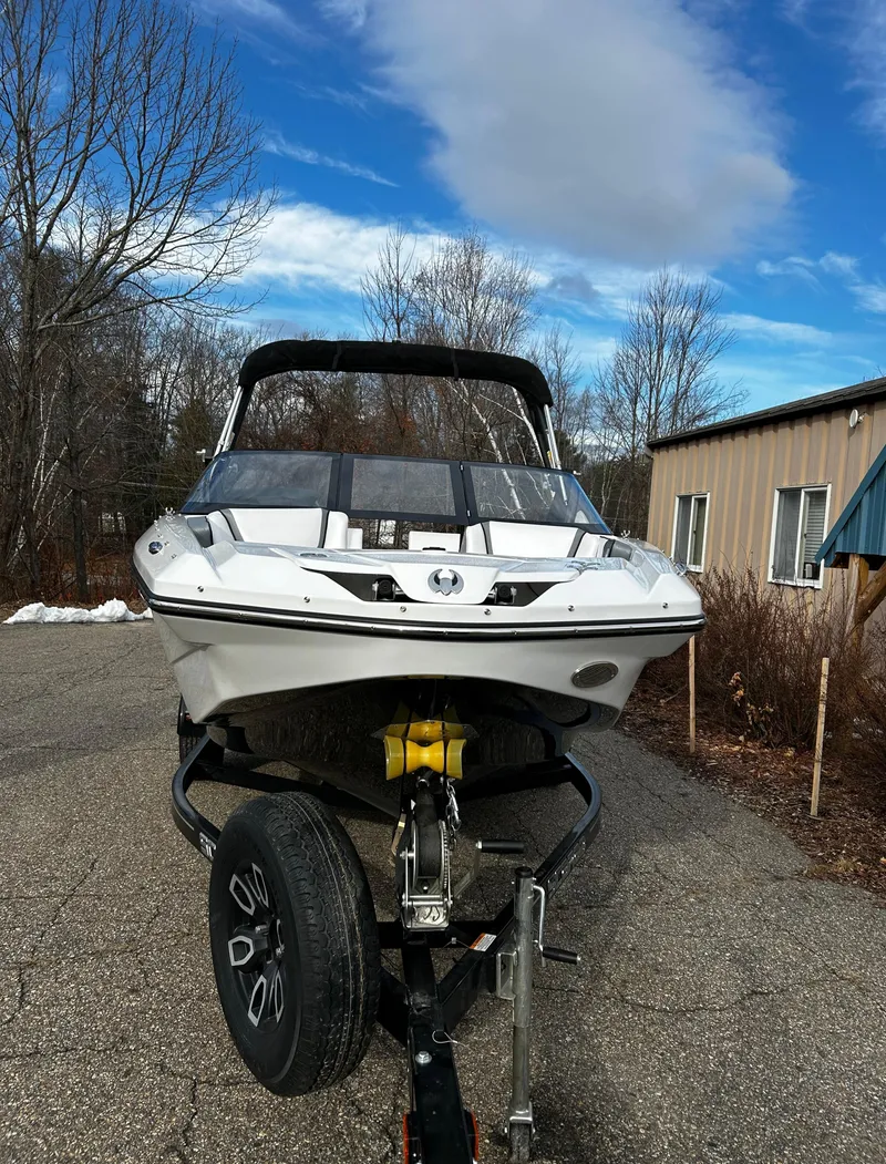 Slide: The Image of 2024 Scarab 215 Wake LE boat on a trailer in a driveway. - 41