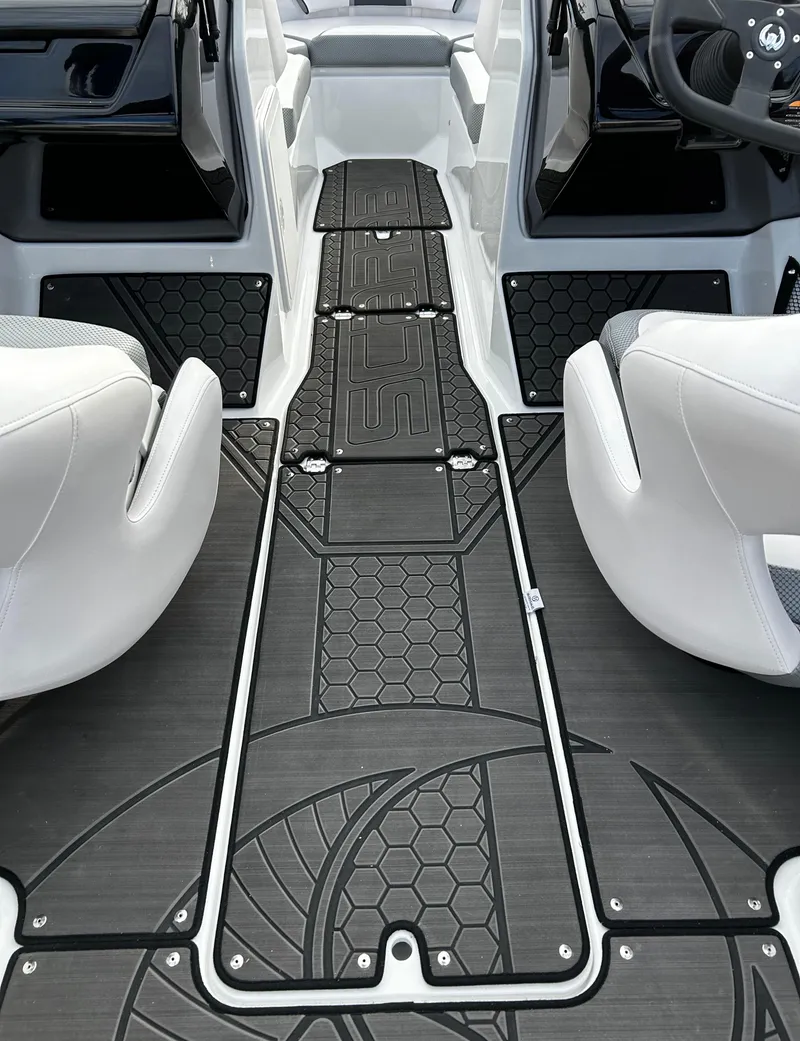Slide: The Image of 2024 Scarab 215 Wake LE boat interior with stylish black flooring and white seats. - 47