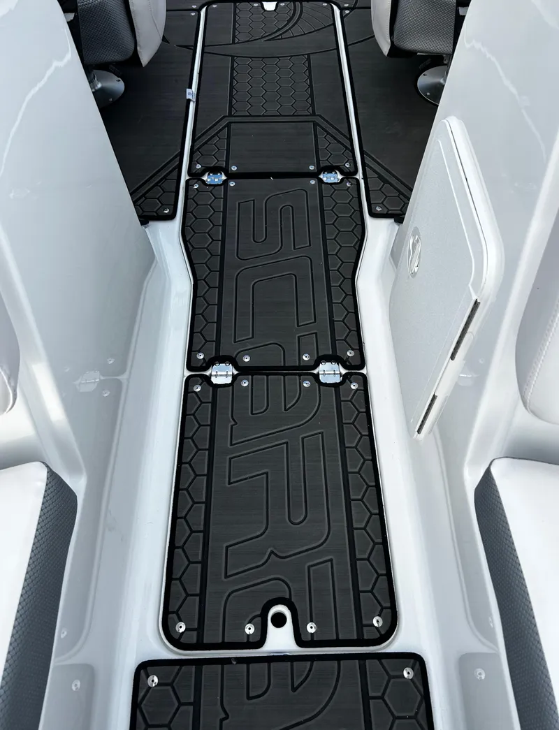 Slide: The Image of 2024 Scarab 215 Wake LE boat interior with custom black flooring. - 51