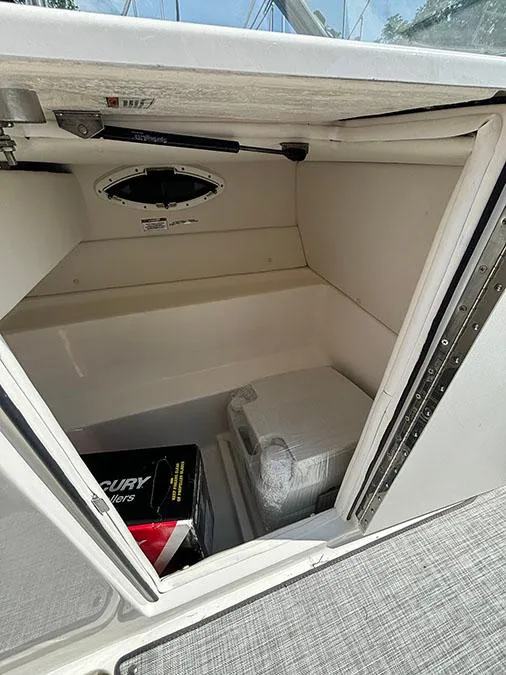 Slide: The Image of 2024 Bayliner VR6 boat storage compartment with Mercury accessories. - 8