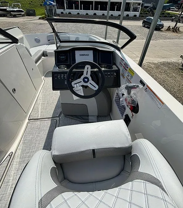 Slide: The Image of 2024 Bayliner VR6 boat cockpit with steering wheel and control panel. - 5