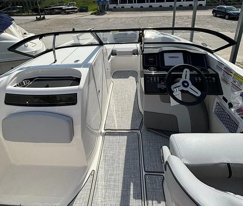 Slide: The Image of 2024 Bayliner VR6 boat interior with steering console and seating area. - 9