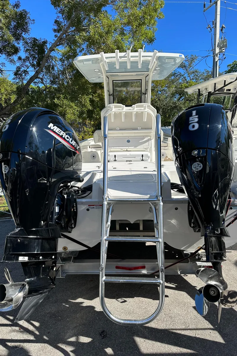 Slide: The Image of 2024 World Cat 235 CC boat with dual Mercury outboard engines. - 2