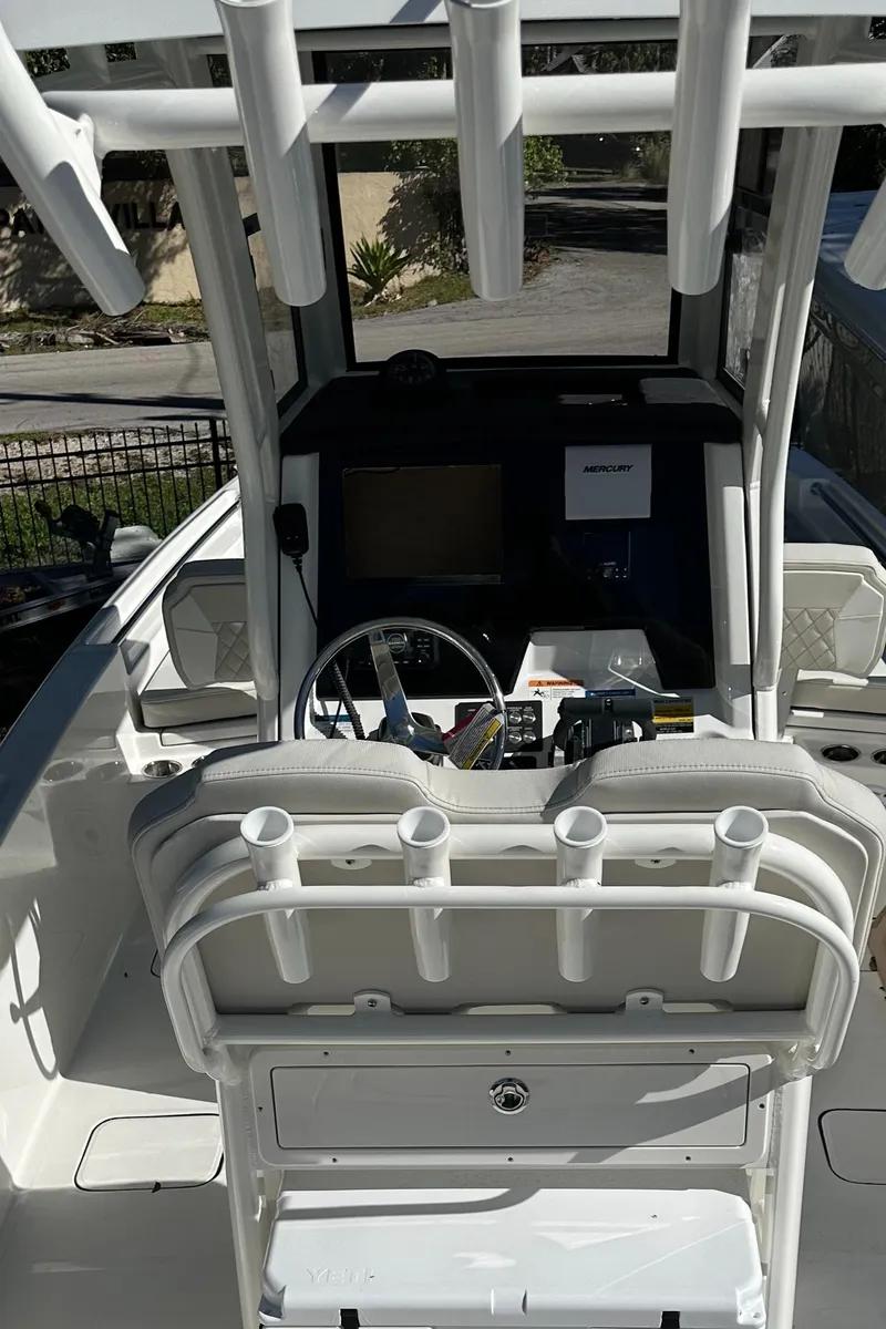 Slide: The Image of 2024 World Cat 235 CC center console boat interior with helm and seating. - 7