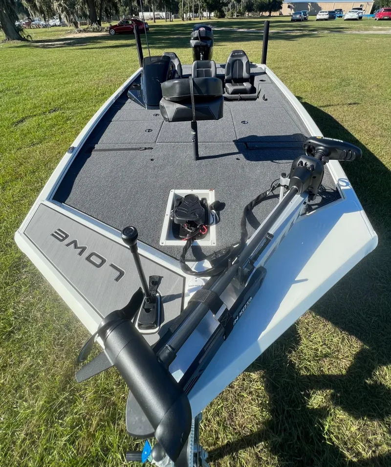 Slide: The Image of 2024 Lowe Stinger 188 SC fishing boat on grass. - 2