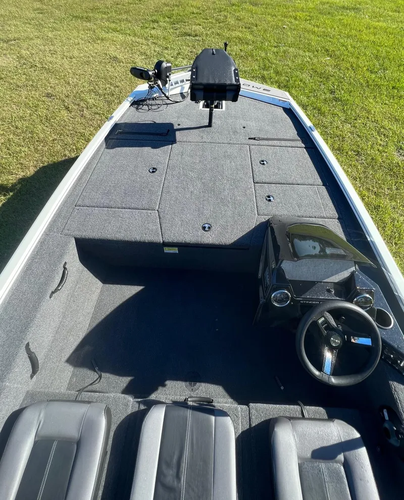Slide: The Image of 2024 Lowe Stinger 188 SC fishing boat with spacious deck and modern controls. - 5