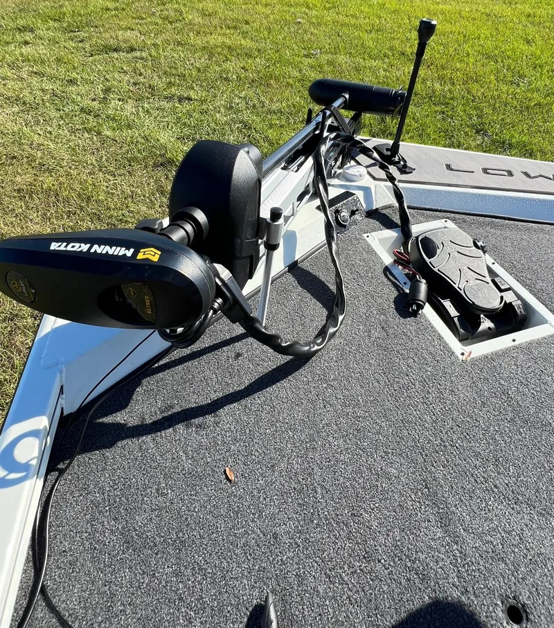 Slide: The Image of 2024 Lowe Stinger 188 SC boat with Minn Kota trolling motor on deck. - 7
