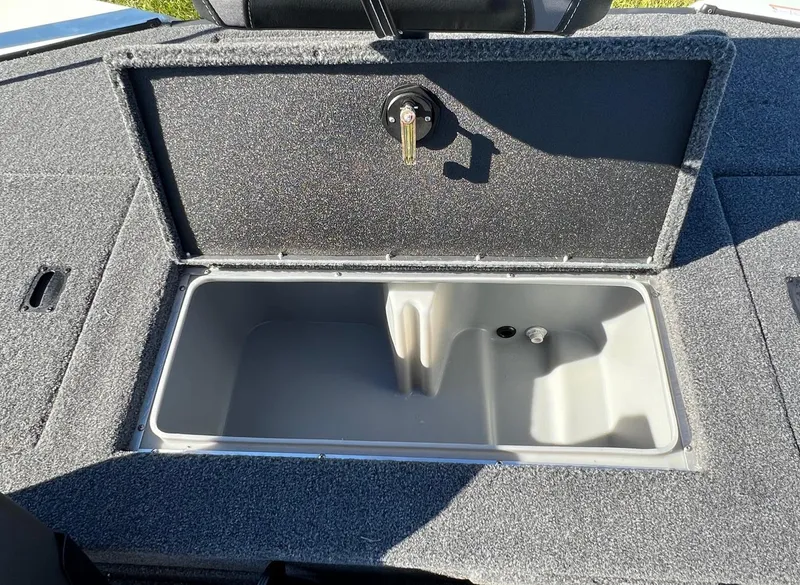 Slide: The Image of 2024 Lowe Stinger 188 SC boat storage compartment with open lid. - 8