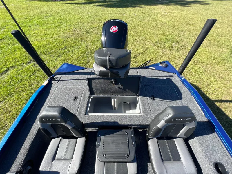Slide: The Image of 2024 Lowe Stinger 198 SC boat interior with seating and storage compartments. - 2