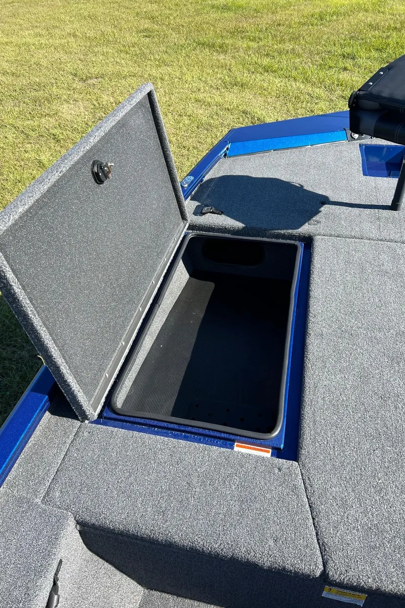 Slide: The Image of 2024 Lowe Stinger 198 SC boat storage compartment open on deck. - 4