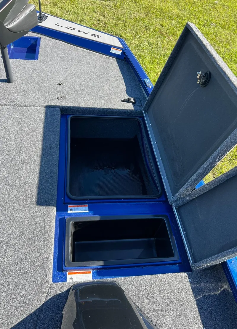 Slide: The Image of 2024 Lowe Stinger 198 SC boat storage compartments open on deck. - 5