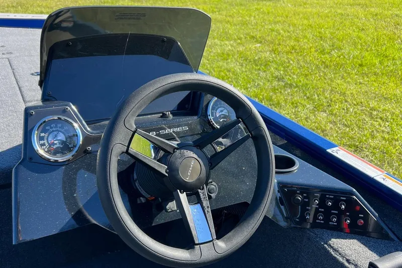 Slide: The Image of 2024 Lowe Stinger 198 SC boat dashboard with steering wheel and control panel. - 6