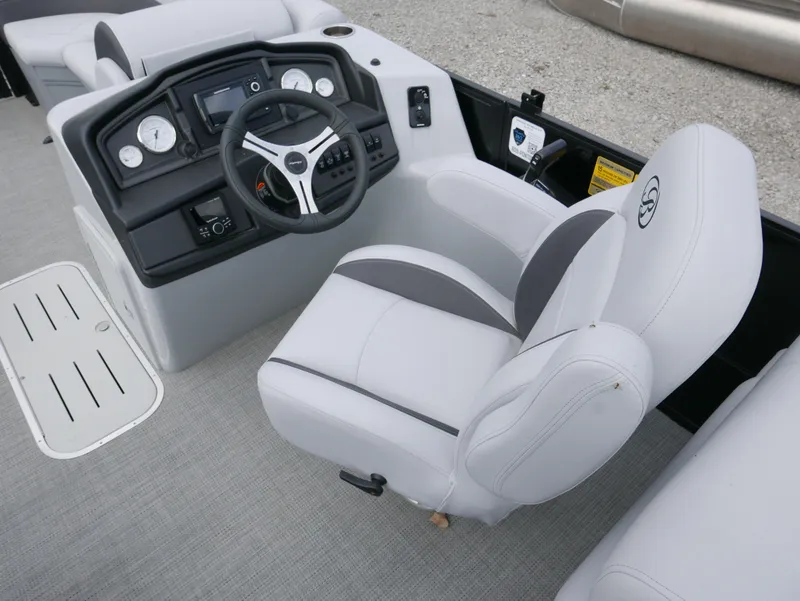Slide: The Image of 2024 Bentley Pontoons Legacy 223 QSB helm with modern controls and comfortable seating. - 14