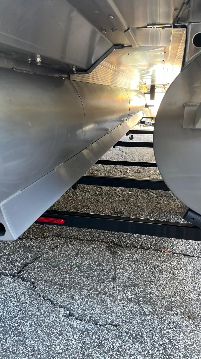 Slide: The Image of Close-up view of the underside of a 2021 Bennington S20 pontoon boat. - 18