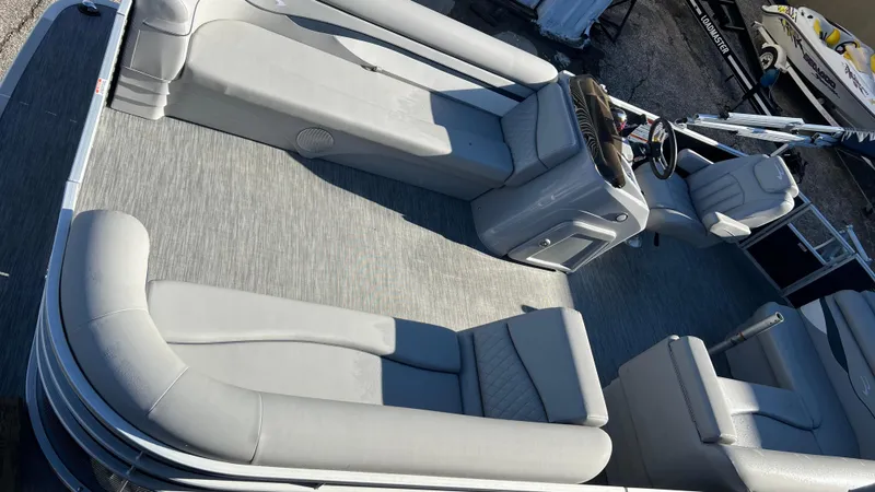 Slide: The Image of 2021 Bennington S20 pontoon boat interior with gray seating and steering console. - 2