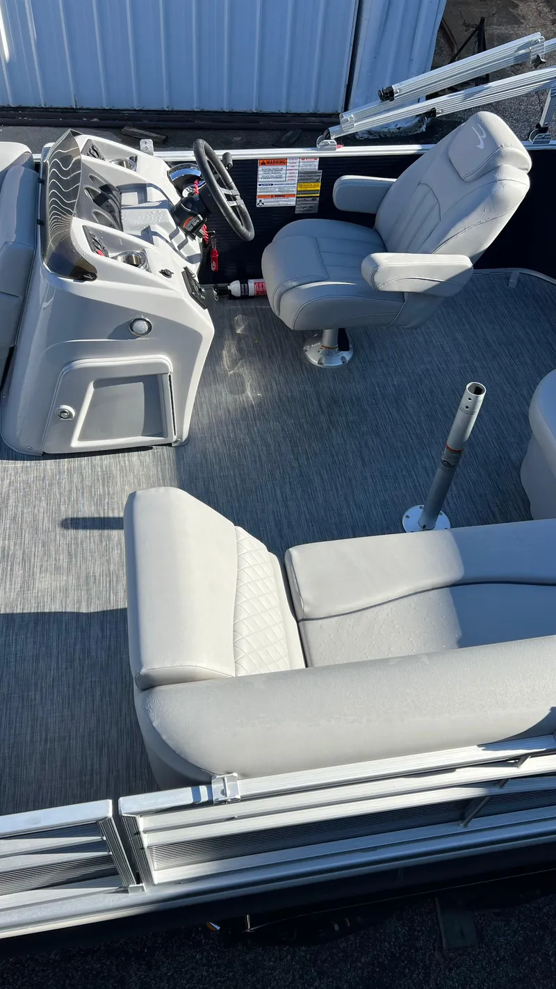 Slide: The Image of 2021 Bennington S20 boat interior with helm, captain's chair, and passenger seating. - 3