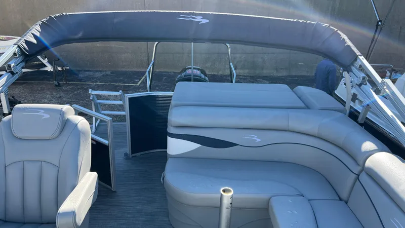 Slide: The Image of 2021 Bennington S20 pontoon boat interior with gray seating and canopy. - 5