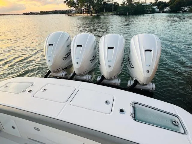 Slide: The Image of 2024 Regulator 41 boat with four powerful outboard engines on a serene water backdrop. - 15